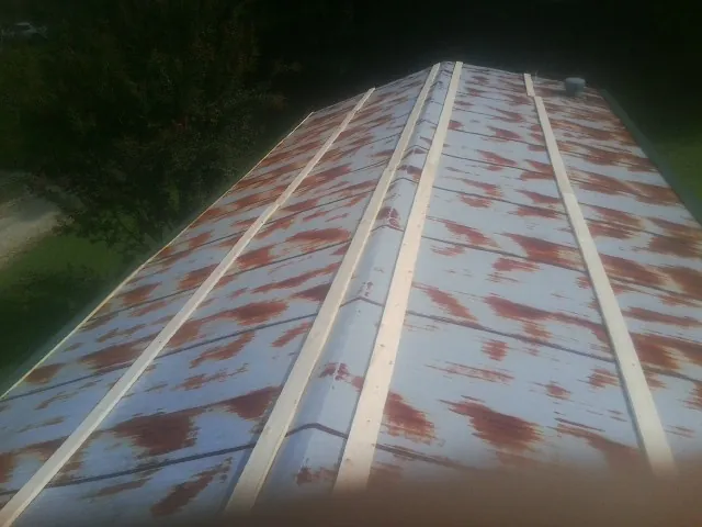 Rusted metal roof panels with new wood purlins before replacement — Storm Damage Roof Repair in Totowa by Roofing Brothers