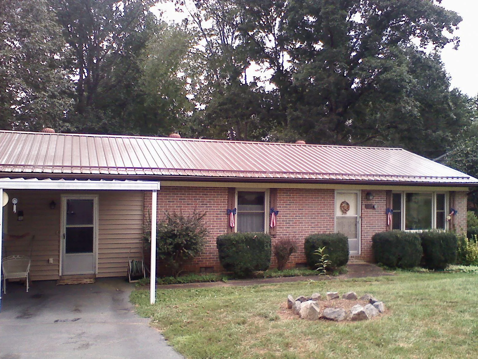 Bronze metal roof and carport on a brick ranch home — Roof Repair work by our crew in Totowa